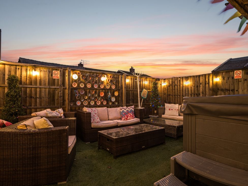 An outdoor seating area with sofa and coffee table at The Boars Head Pub in Bishop's Castle
