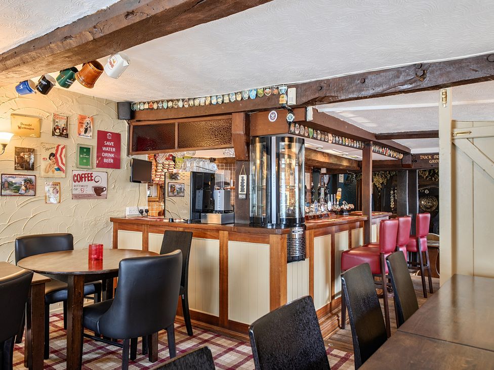 A restaurant with bar and seating at The Boars Head Pub in Bishop's Castle
