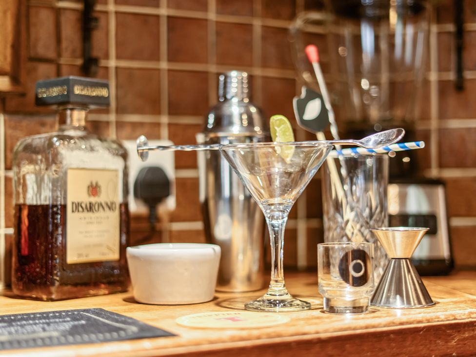 A bar setup with a cocktail glass and various tools at The Boars Head Pub in Bishop's Castle