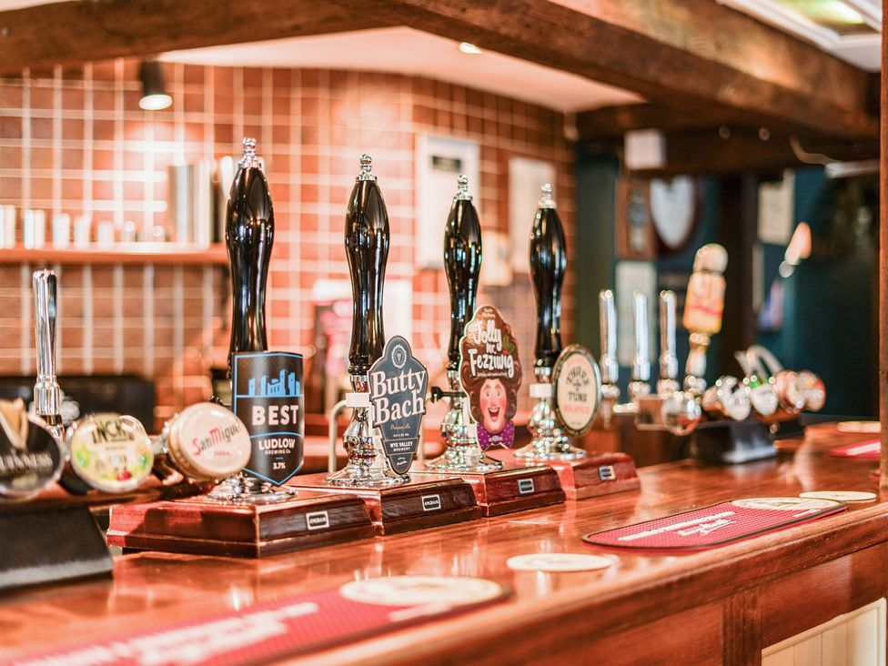 A bar counter with various beer taps at The Boars Head Pub in Bishop's Castle