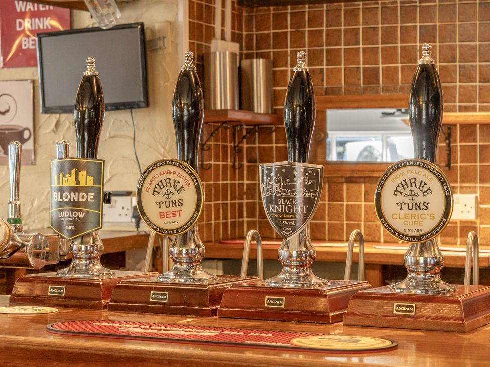 A bar area with beer taps on counter at The Boars Head Pub in Bishop's Castle
