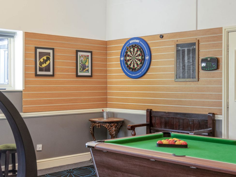 A games room with a dartboard and pool table at The Boars Head Pub in Bishop's Castle