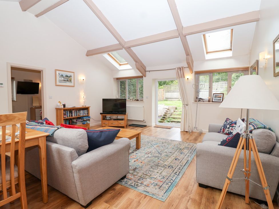 A living room with a sofa and coffee table at Tregona Buckland Monachorum near Yelverton