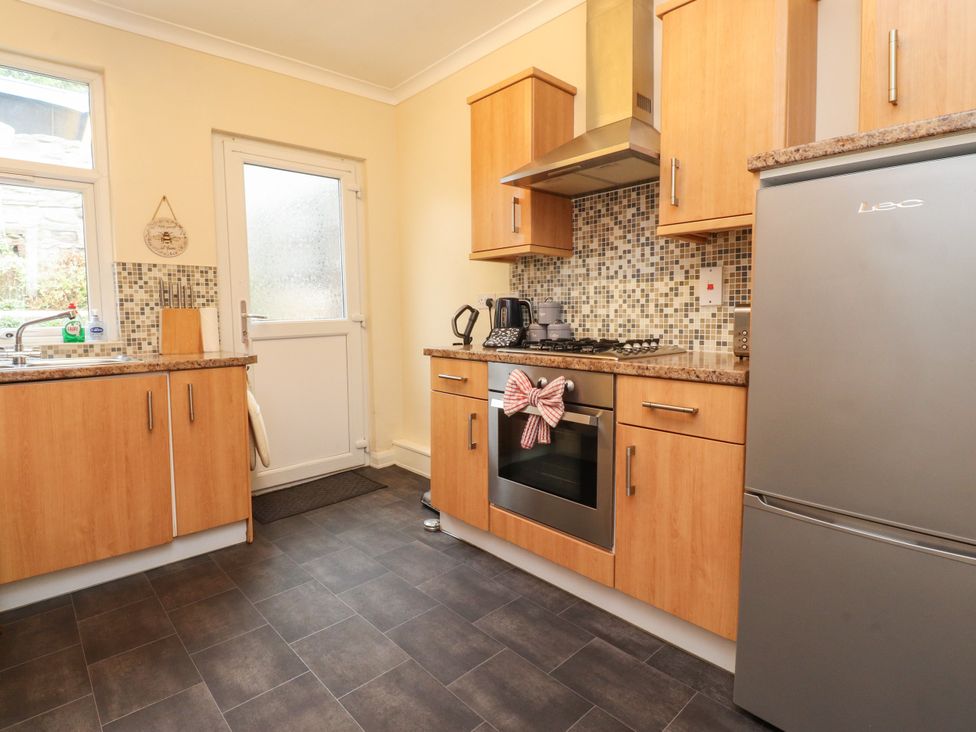 A kitchen with a sink and an oven at Cosy Bee in Heysham