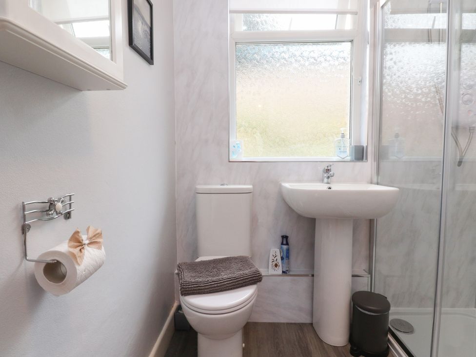A bathroom with a toilet and sink at Cosy Bee in Heysham