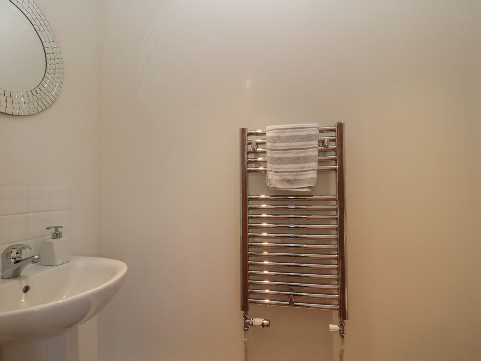 A bathroom with a sink and a towel rail at Bramble Cottage Somerton