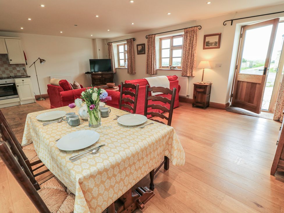 A dining room with a table set for meals at Bramble Cottage Babcary near Lydford-On-Fosse