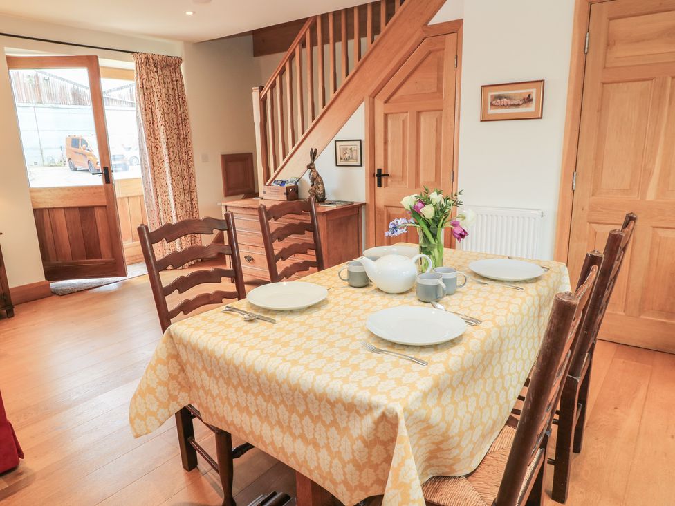 A dining room with a table set for a meal at Bramble Cottage Babcary near Lydford-On-Fosse