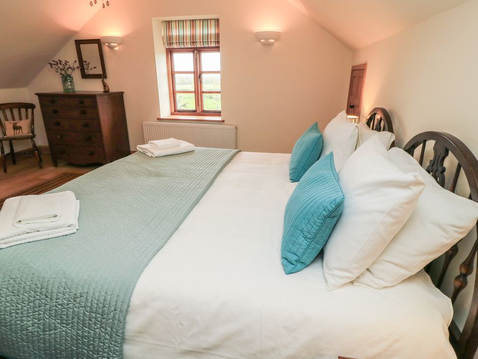 A bedroom with a bed and dresser at Bramble Cottage in Babcary near Lydford-On-Fosse