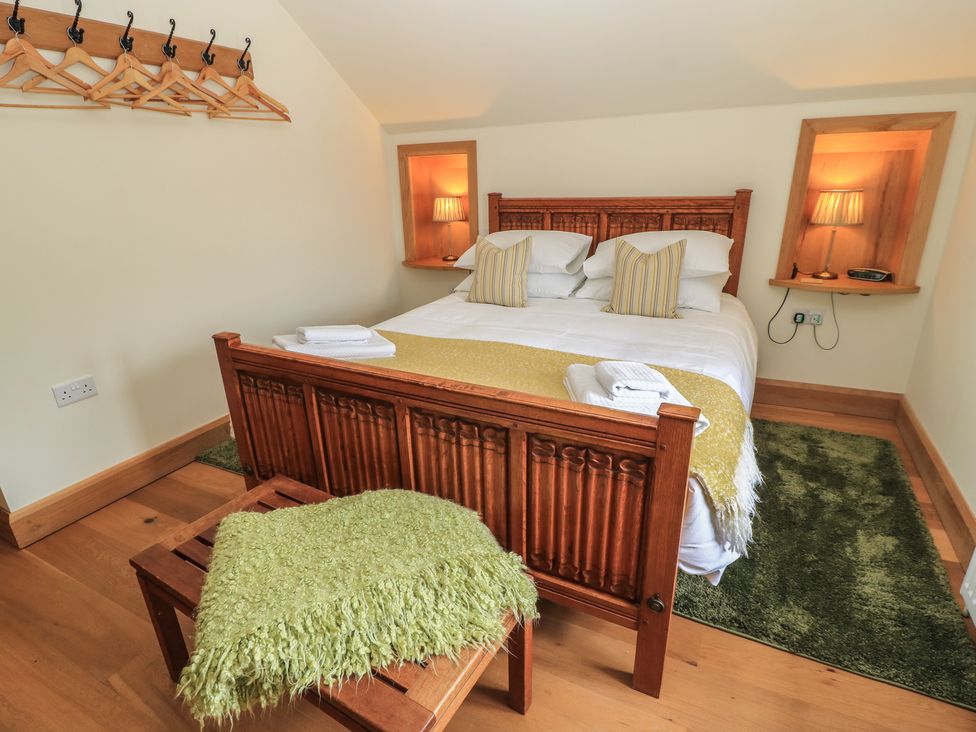 A bedroom with a bed and storage space at Badger Cottage Babcary near Lydford-On-Fosse