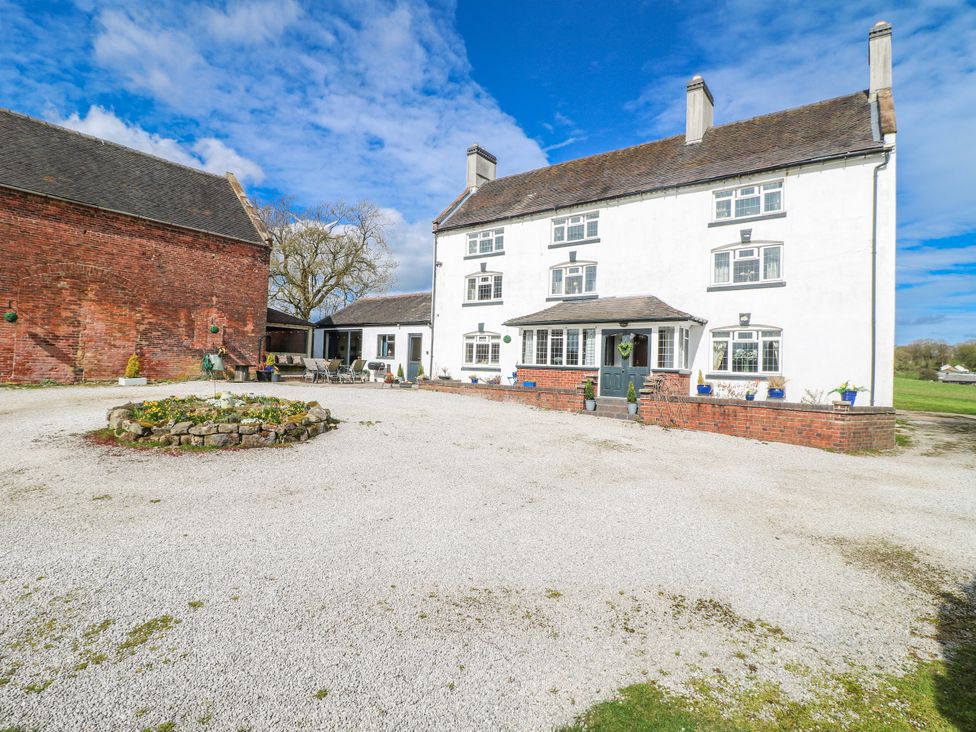 A residential building with a gravel driveway and garden area at Fields Farm in Cheadle