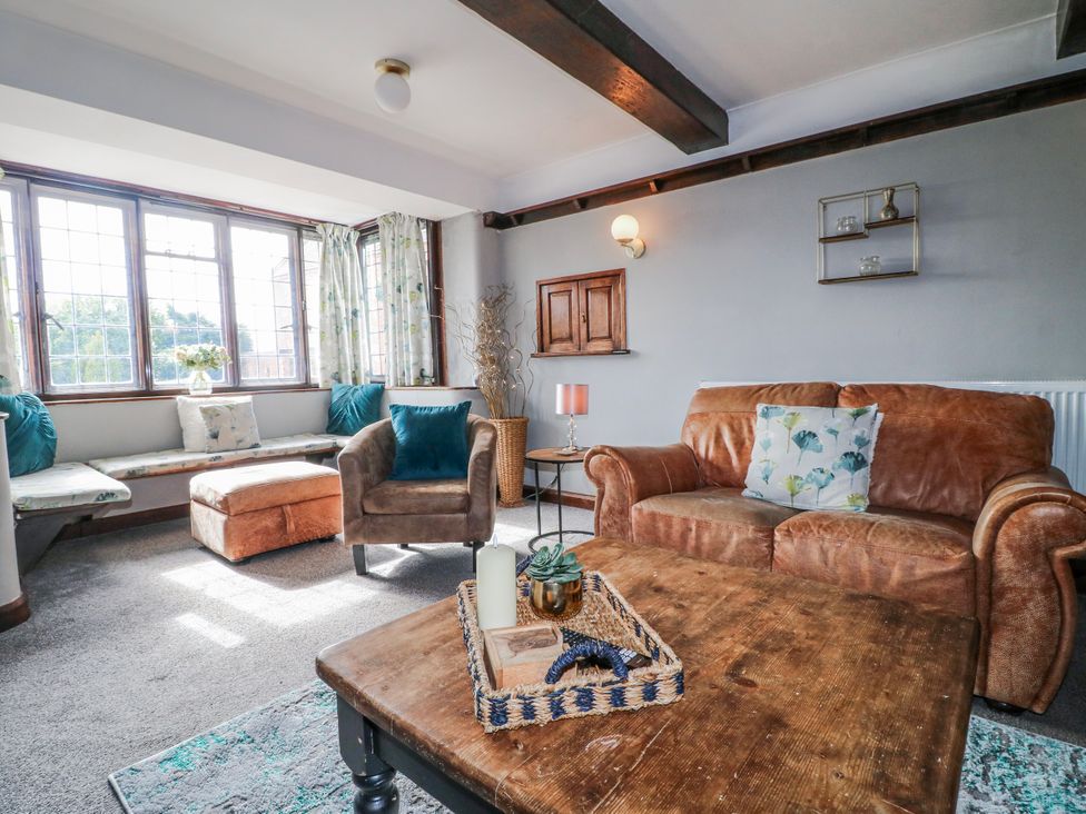 A living room with a sofa and coffee table at Fields Farm in Cheadle