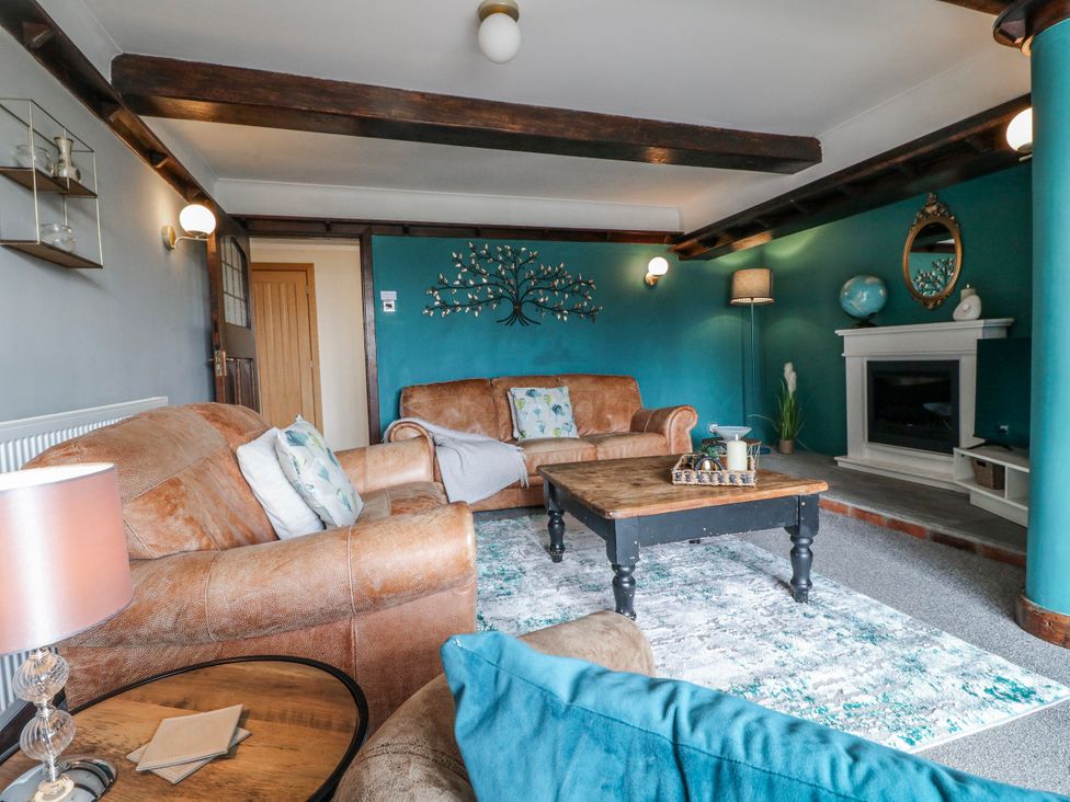 A living room with a sofa and coffee table at Fields Farm in Cheadle