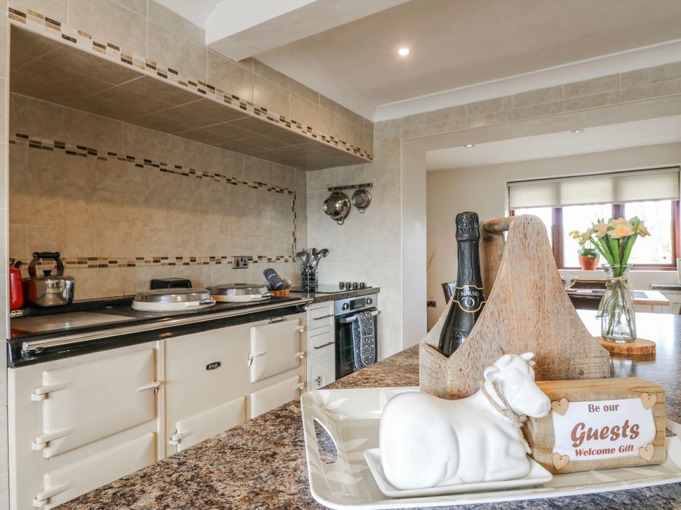 A kitchen with appliances and decorative items at Fields Farm in Cheadle