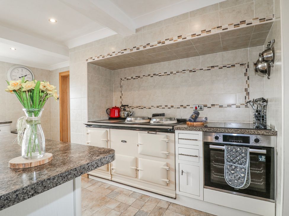 A kitchen with an oven and sink at Fields Farm in Cheadle