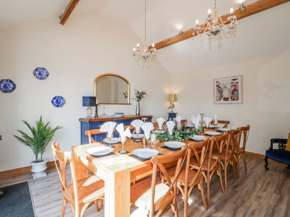 A dining room with a large table and chairs at Fields Farm in Cheadle