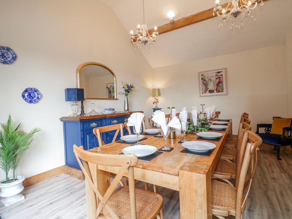 A dining room with a large table and chairs at Fields Farm in Cheadle