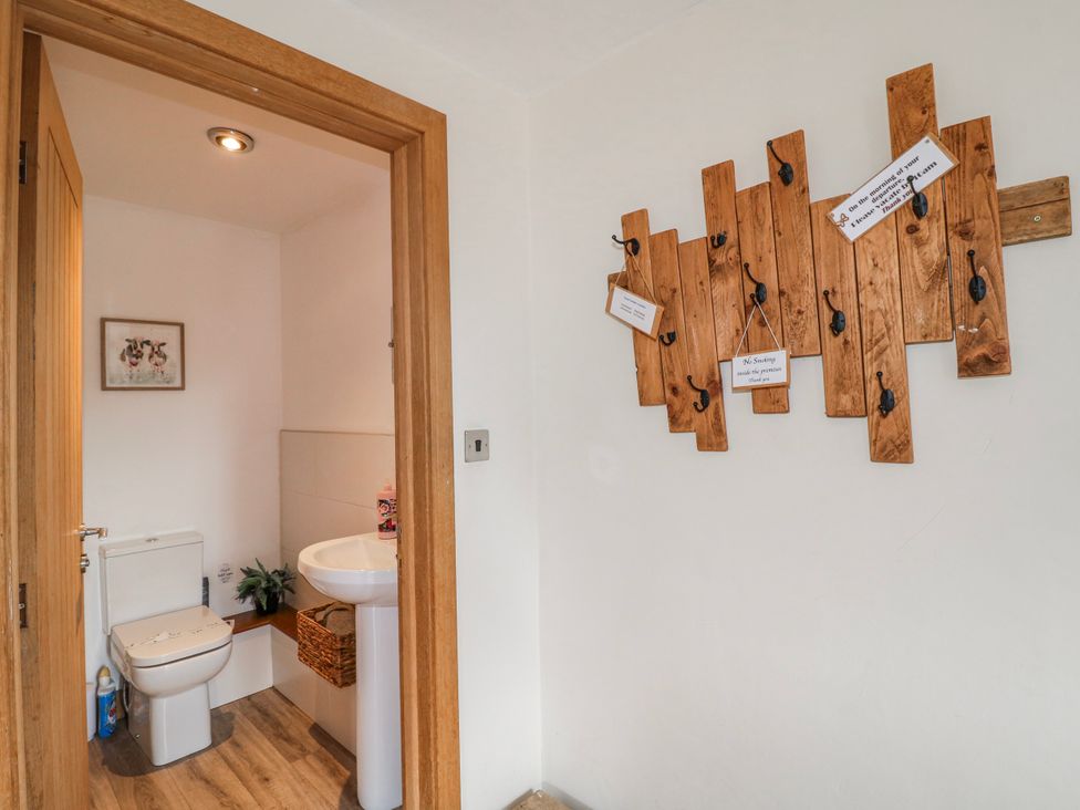 A bathroom with a toilet and a washbasin at Fields Farm in Cheadle