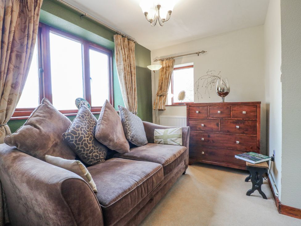 A living room with a sofa and chest of drawers at Fields Farm in Cheadle