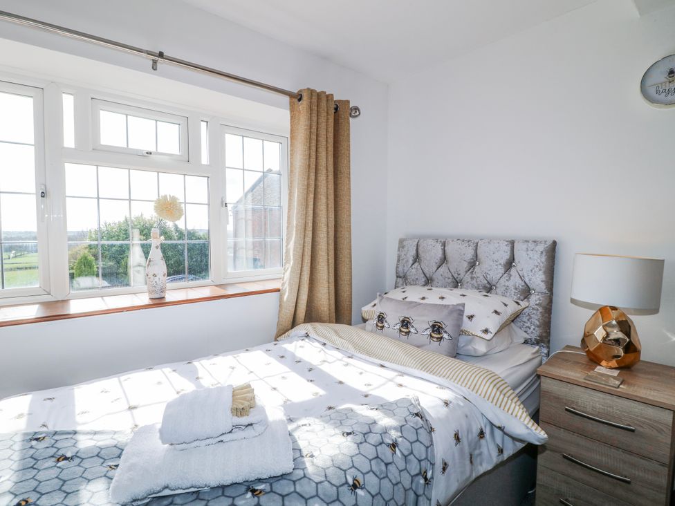 A bedroom with a bed and window at Fields Farm in Cheadle
