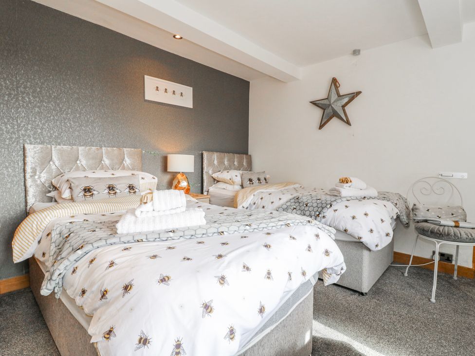 A bedroom with three beds and a decorative star at Fields Farm Cheadle