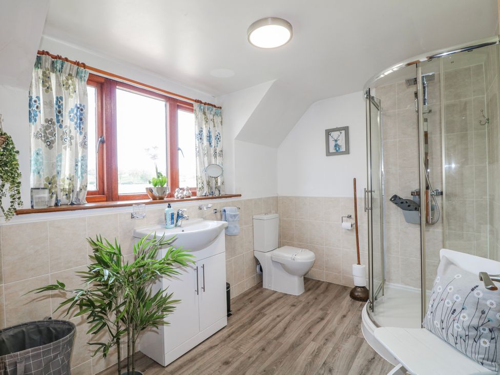 A bathroom with shower, sink and toilet at Fields Farm in Cheadle