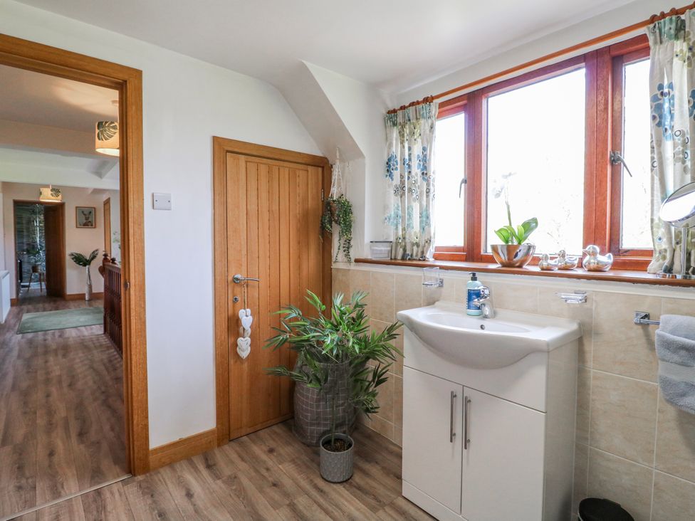 A bathroom with a sink and window at Fields Farm in Cheadle