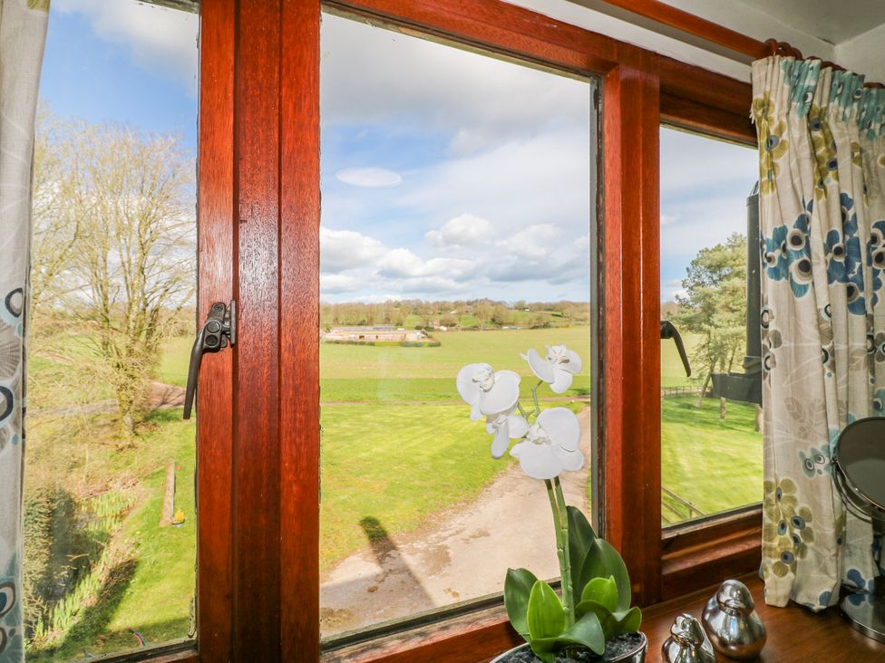 A window with a view of a field and plant at Fields Farm in Cheadle