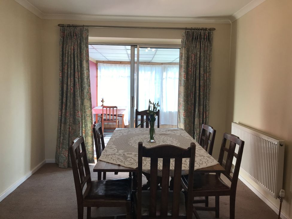 A dining room with a table and chairs at Lavender Harmony House in Swindon