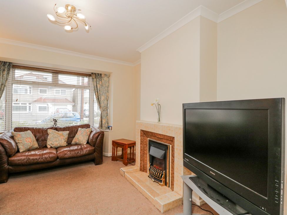A living room with a sofa and a television at Lavender Harmony House in Swindon