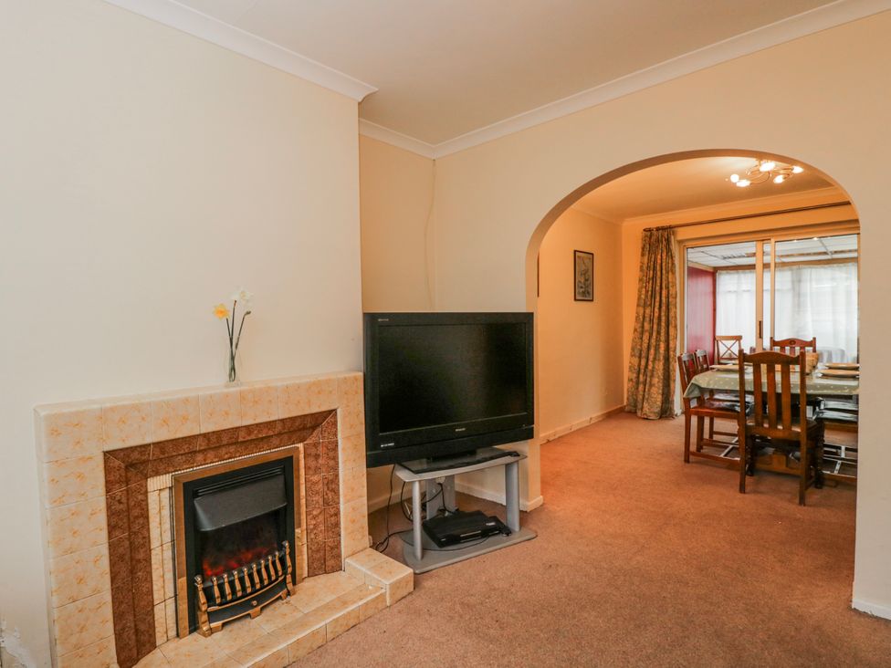 A living room with a fireplace and television at Lavender Harmony House in Swindon