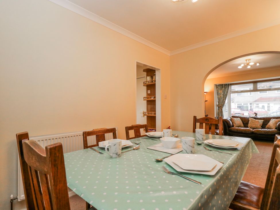 A dining room with a table set for meals at Lavender Harmony House in Swindon