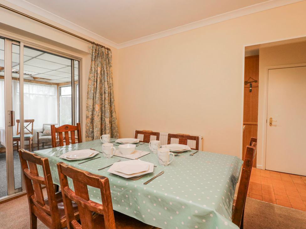 A dining room with a table set for meals at Lavender Harmony House in Swindon