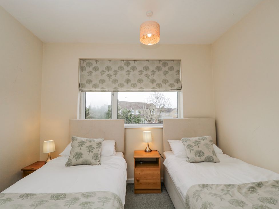 A bedroom with two beds and a window at Lavender Harmony House in Swindon