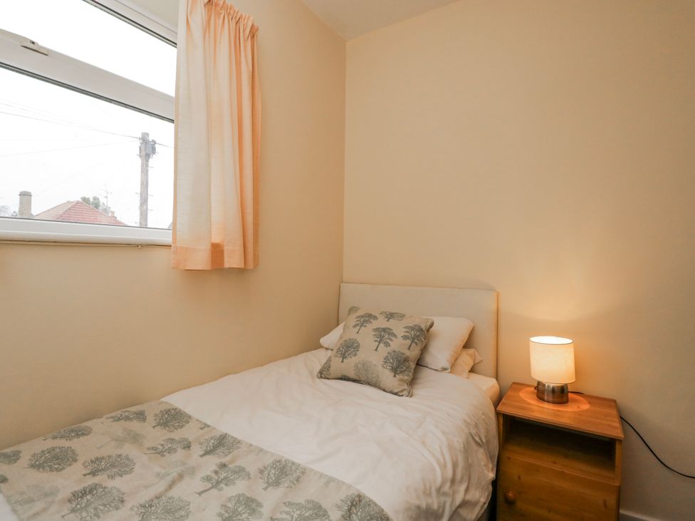 A bedroom with a single bed and bedside table at Lavender Harmony House in Swindon