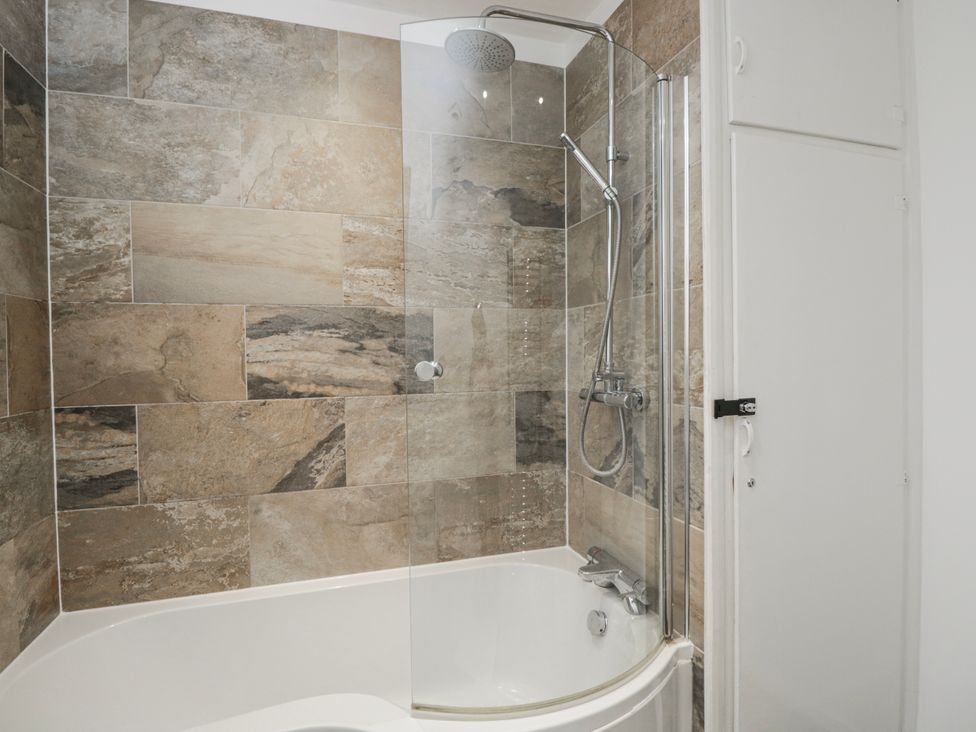 A bathroom with a shower and bathtub at Lavender Harmony House in Swindon