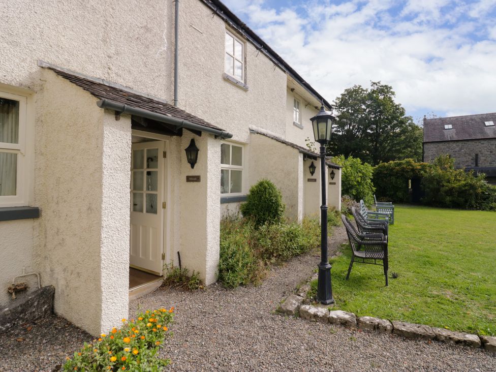 An exterior view of a house with a garden at Longlands Milkmaid's Parlour near Grange-over-Sands