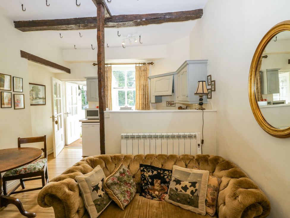 A living room with a sofa and table at Longlands Milkmaid's Parlour in Cartmel near Grange-over-Sands