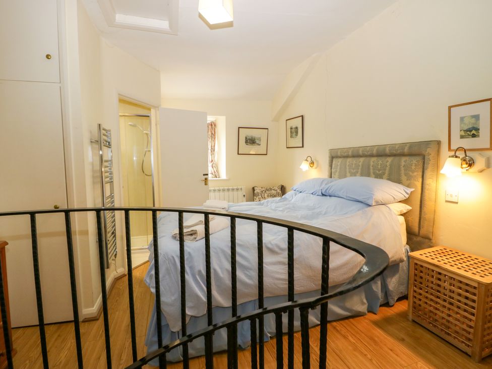 A bedroom with a bed and a shower in Longlands Milkmaid's Parlour Cartmel near Grange-over-Sands