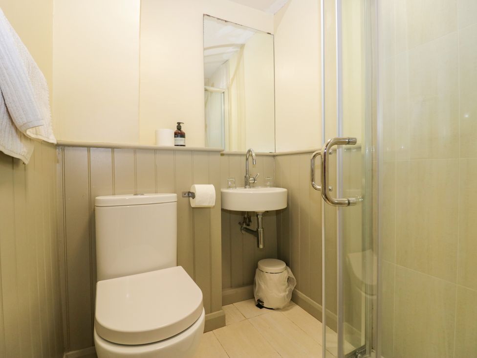 A bathroom with a toilet, sink, and shower at Longlands Milkmaid's Parlour in Cartmel near Grange-over-Sands