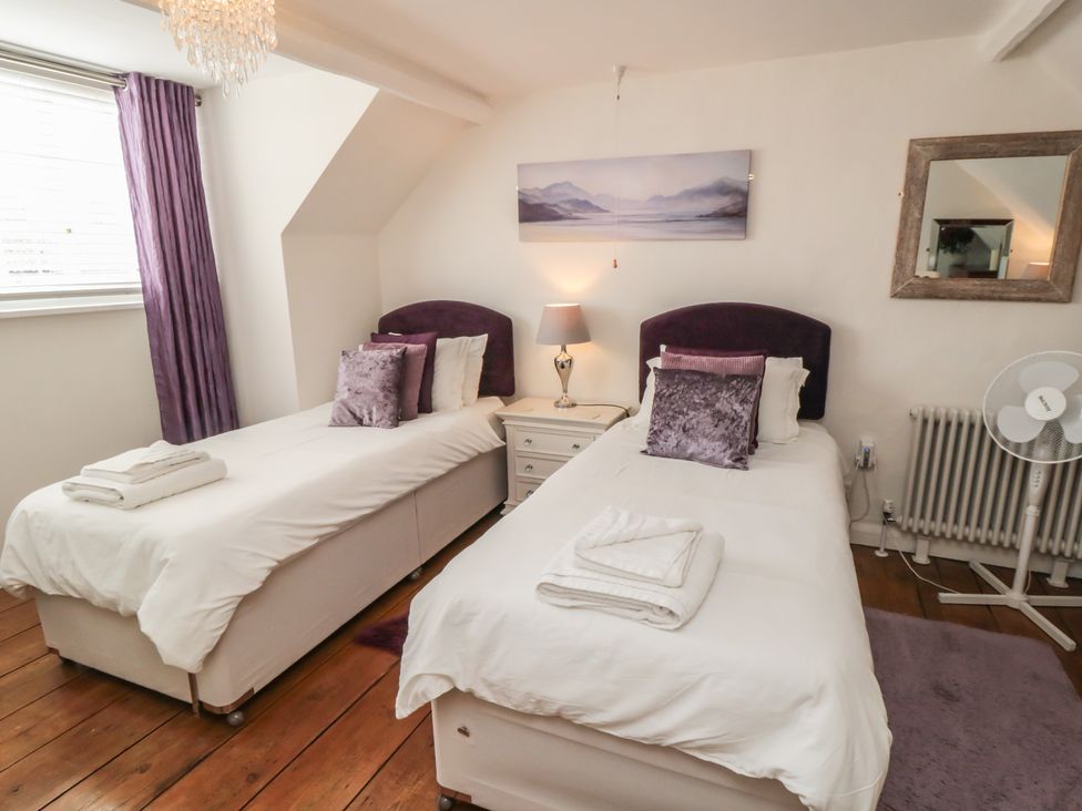 A bedroom with two single beds and a nightstand at Dove Cottage in Pickering