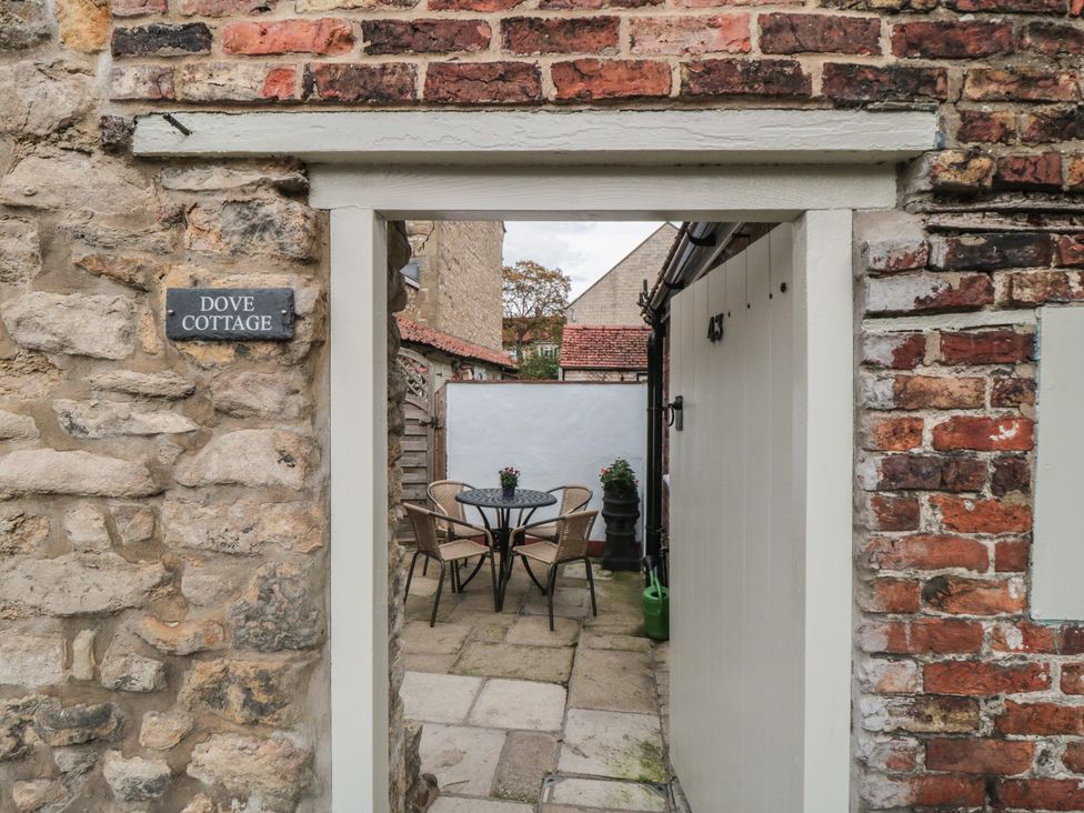 An outdoor area with a table and chairs at Dove Cottage in Pickering