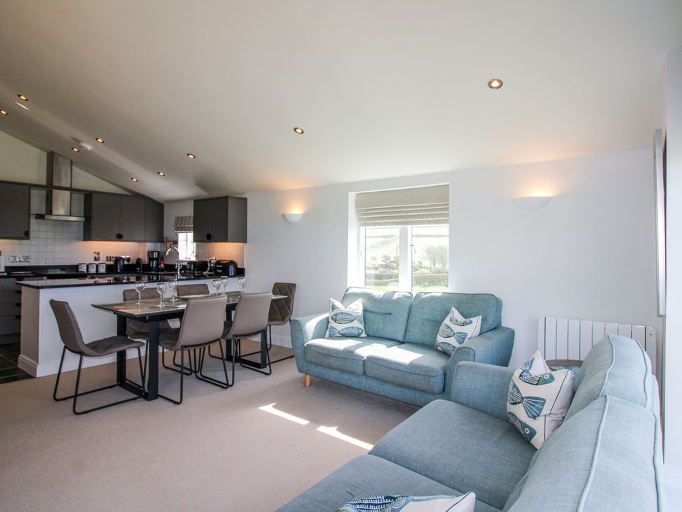 A living room with a dining area and kitchen at 7 Ocean's Edge Thurlestone