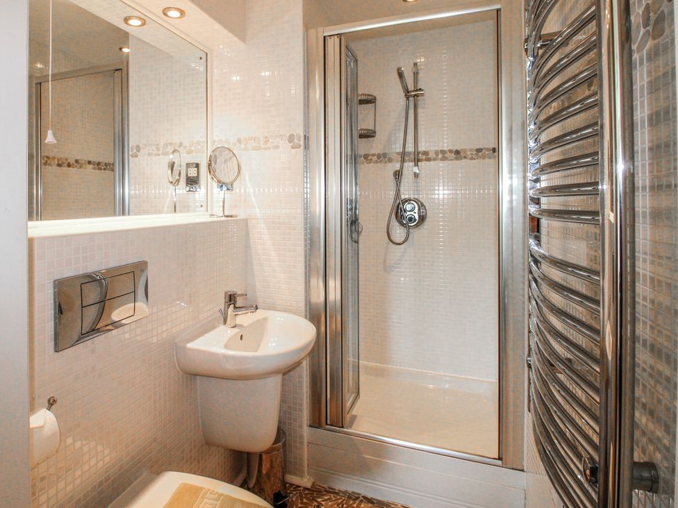A bathroom with a shower and sink at 7 Ocean's Edge Thurlestone