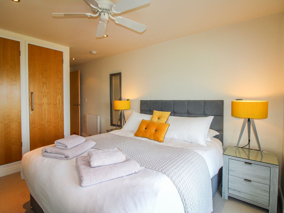 A bedroom with a double bed and nightstand at 7 Ocean's Edge Thurlestone