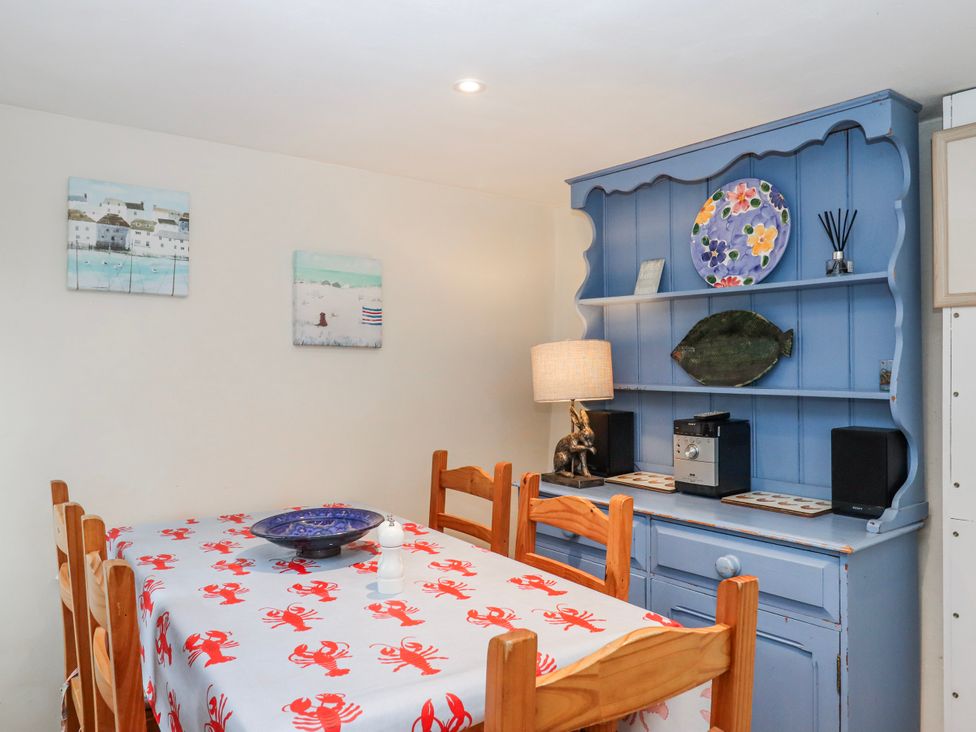 A dining room with a table and chairs at Yew Tree Cottage in Stoke Fleming