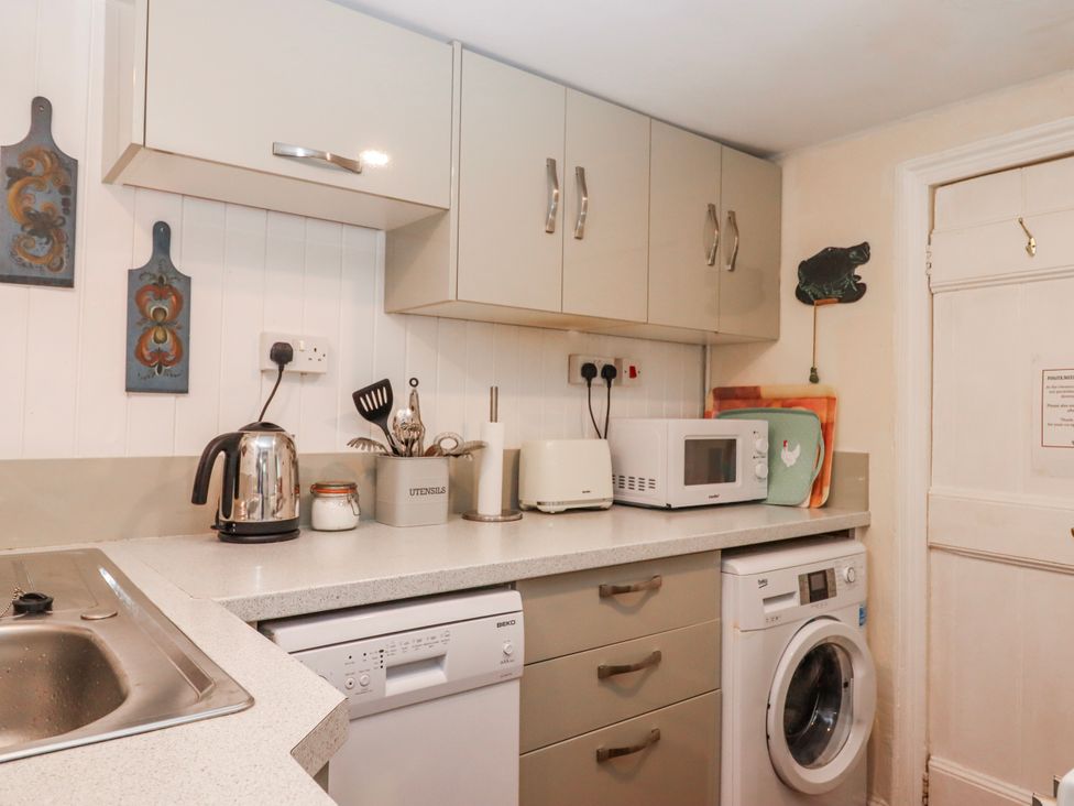 A kitchen with kitchen appliances at Yew Tree Cottage Stoke Fleming