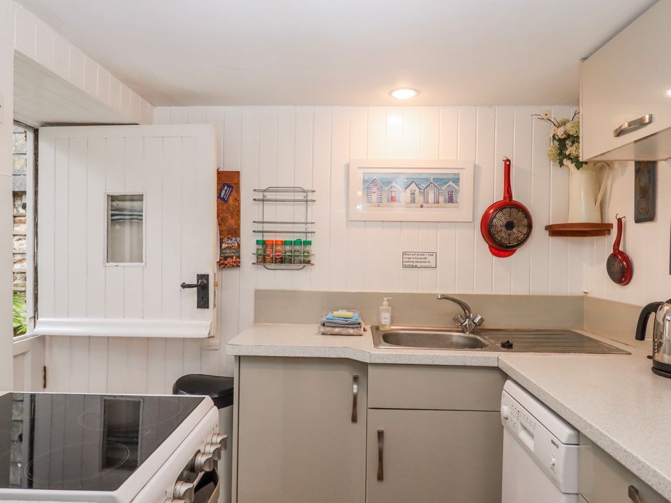 A kitchen with a sink and oven at Yew Tree Cottage in Stoke Fleming