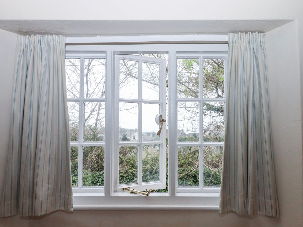 A window with curtains at Yew Tree Cottage Stoke Fleming