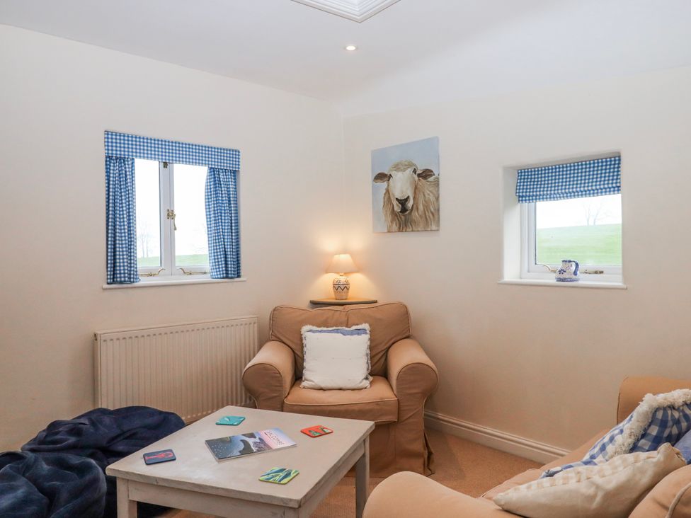 A living room with a sofa and table at Yew Tree Cottage Stoke Fleming